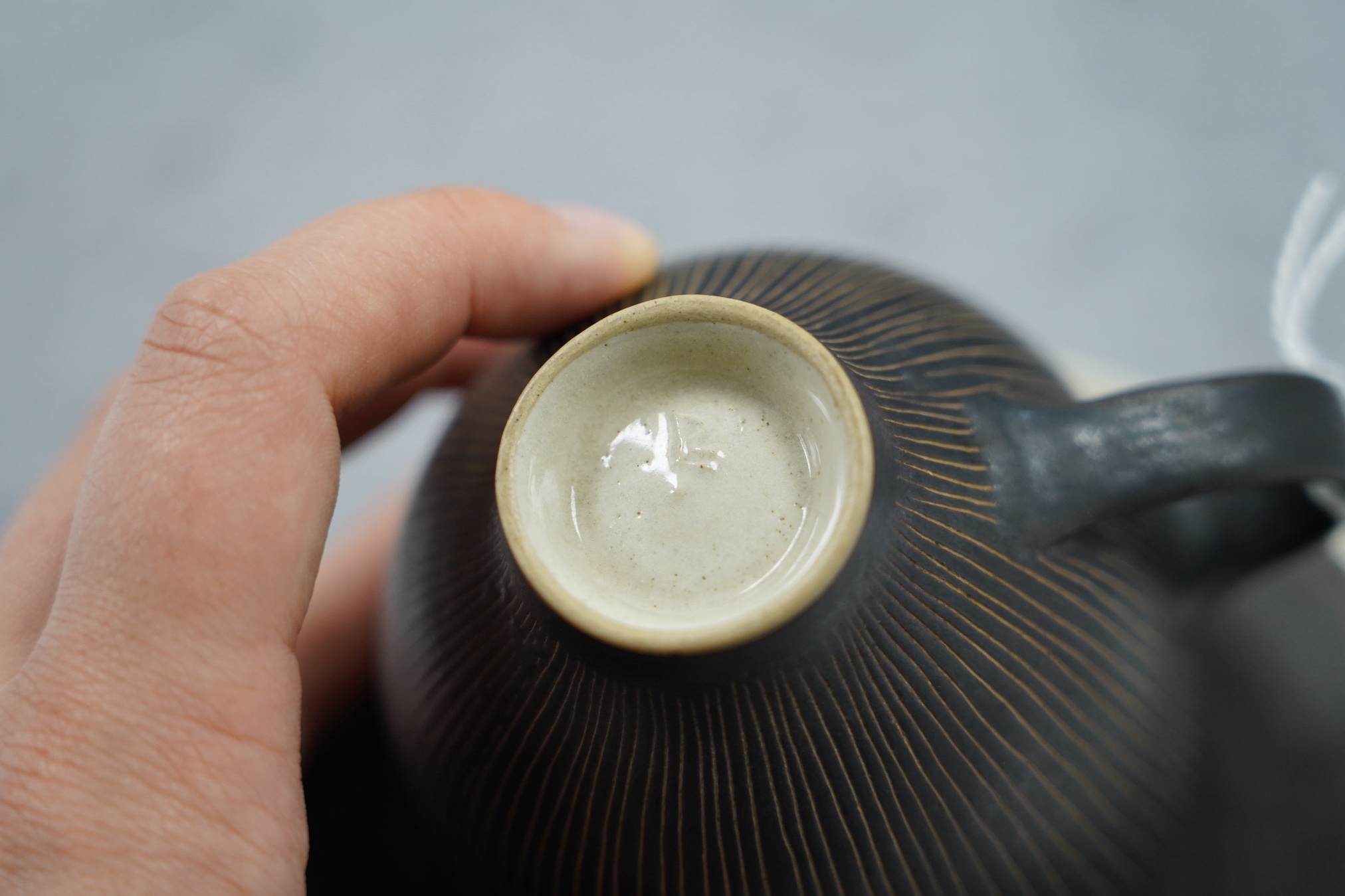 Dame Lucie Rie D.B.E. (1902-1995), a manganese glazed coffee cup and saucer